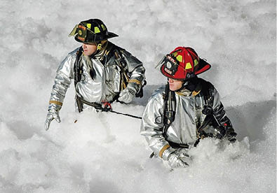 Firefighters srrounded by firefighting foam Firefighters srrounded by firefighting foam