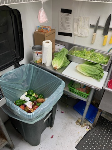 An organics recycling bin in the prep kitchen image from Keith Lasoya at Waste Neutral