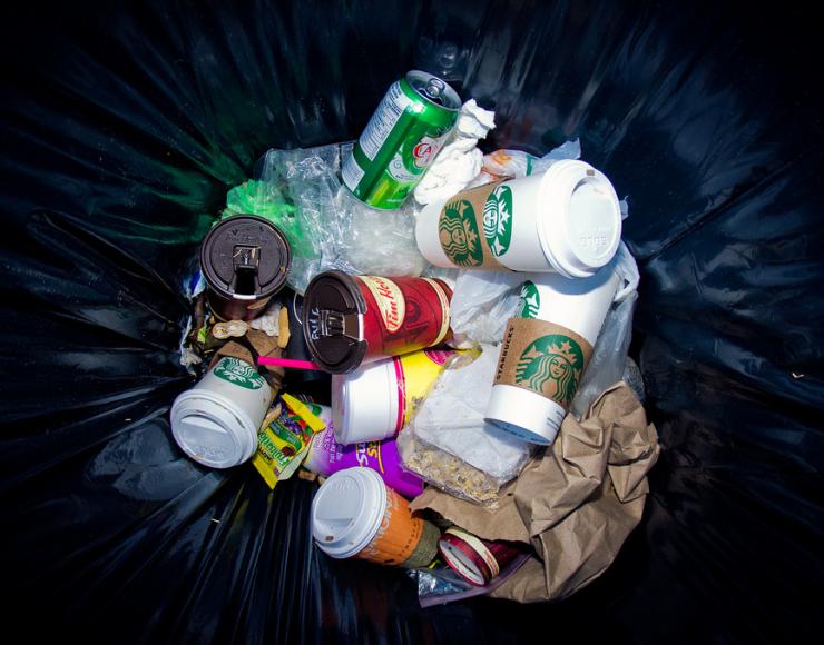 Trash can full of disposable coffee cups Trash can full of disposable coffee cups