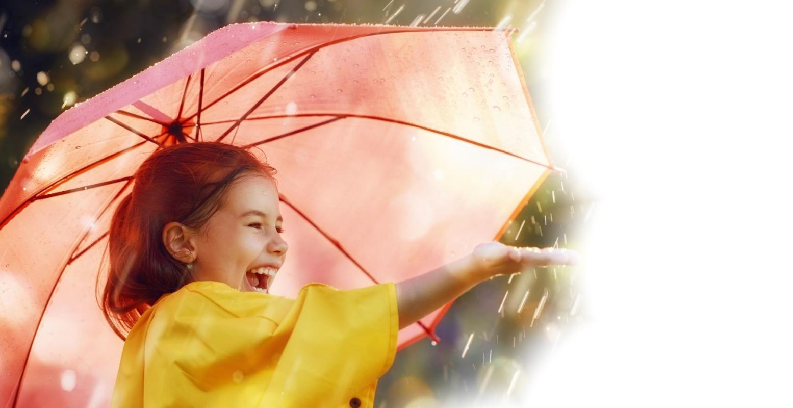 Photo of girl laughing under an umbrella in the rain