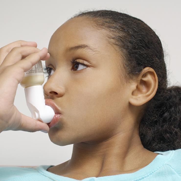Girl using an inhaler Girl using an inhaler