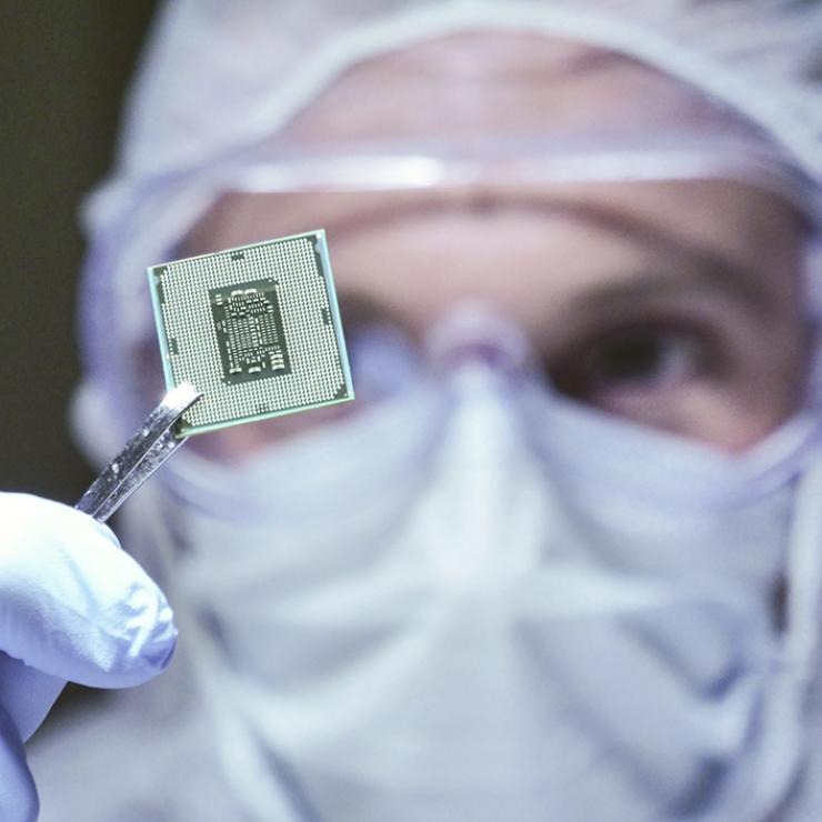 Lab worker holding a microchip Lab worker holding a microchip