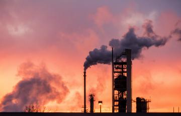 Refinery smokstacks at sunset